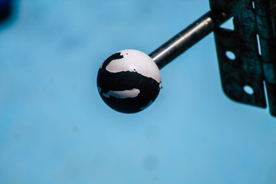 Close-up of blue ball on metal