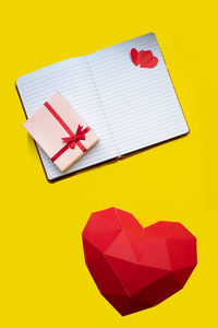 High angle view of heart shapes on yellow background