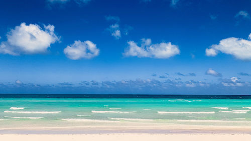 Scenic view of sea against blue sky