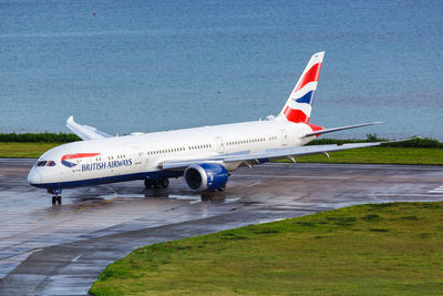 Side view of airplane on airport runway