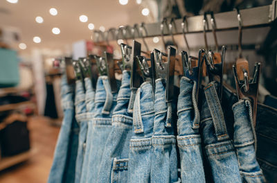 Denim pants in clothing store. jeans on hanger hanging on rack in clothing store. fashion retail