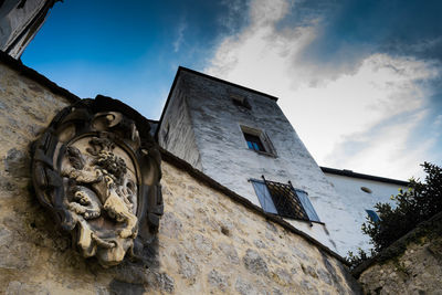 Low angle view of statue against cloudy sky