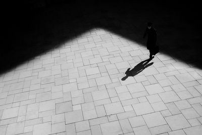 High angle view of man walking on footpath