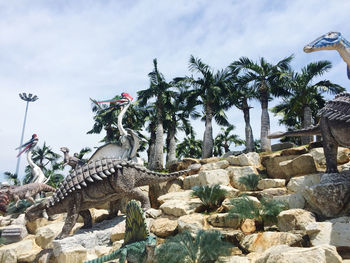 View of giraffe on rock against sky