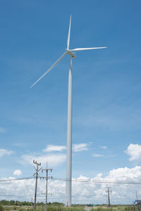 Low angle view of windmill against sky