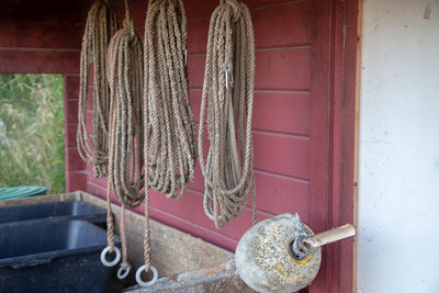 Close-up of rope tied on metal against wall