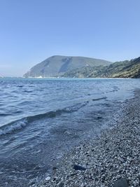 Scenic view of sea against clear blue sky