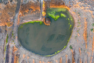 High angle view of old metal structure on lake