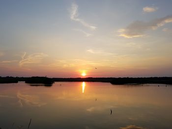 Scenic view of lake against sky during sunset