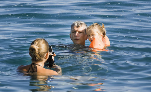 Portrait of mother and girl swimming in water