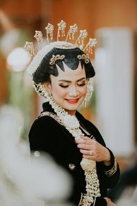 Smiling young woman wearing traditional clothing and jewelries