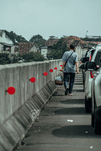 Rear view of people walking on road