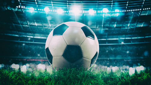 Close-up of soccer ball on field at night