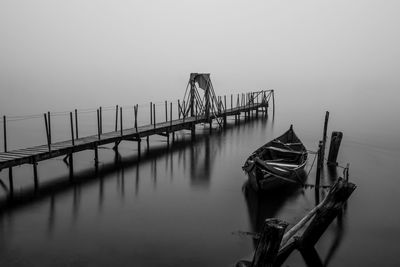 Pier on wooden post against sky