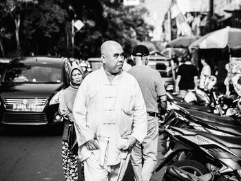 Man standing on street in city