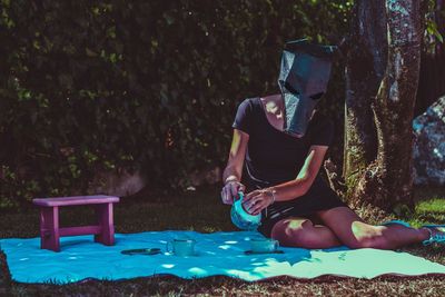 Woman wearing mask at picnic