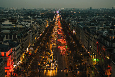 High angle view of illuminated street amidst buildings in city