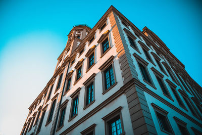 Low angle view of building against clear blue sky