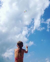 Rear view of girl flying kite