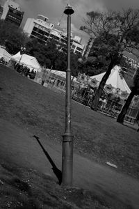 View of street light and trees against sky