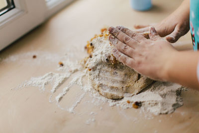 Close-up of woman preparing food on table