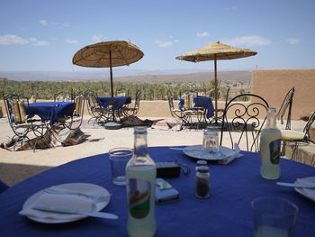 Empty chairs against sky