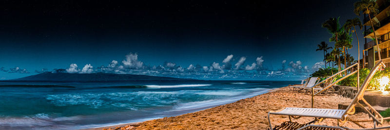 View of beach against blue sky at night