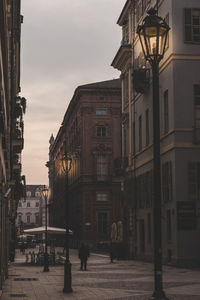 Street amidst buildings against sky in city