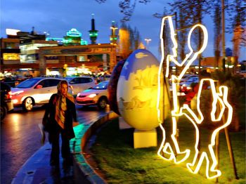 Woman standing in illuminated city at night