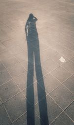 Low section of man standing on shadow