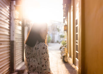 Side view of woman standing outdoors