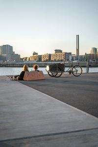Bicycles parked by building in city against sky