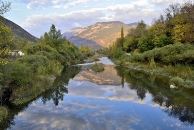 Scenic view of lake and mountains against sky