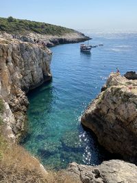 High angle view of sailboats on sea shore against sky