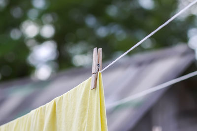 Washed colorful cotton bed sheets hanging on a clothesline outdoors.