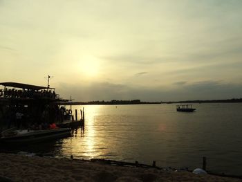 Boats in harbor at sunset