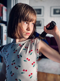 Portrait of cute girl holding camera