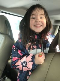 Portrait of cute girl in car