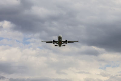 Low angle view of airplane flying in sky