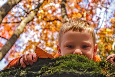 Portrait of boy with autumn leaves