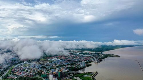 High angle view of city against cloudy sky