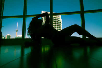 Man and woman against sky seen through window