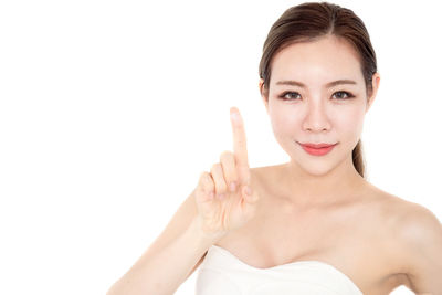 Portrait of a smiling young woman over white background