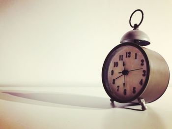 Close-up of clock on table at home