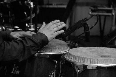 Cropped hands of musician playing drums