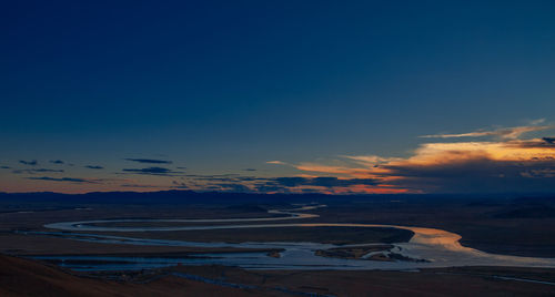 Aerial view of landscape against sky during sunset with river