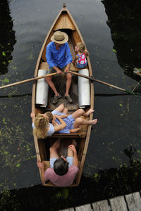 Family in rowing boat, top view