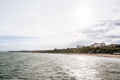 Scenic view of sea against sky in city