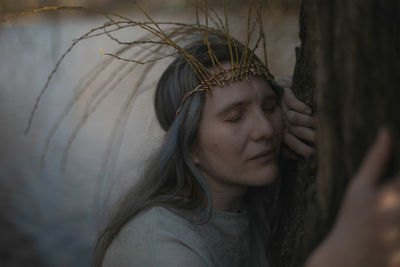 Close up ancient celtic styled woman hugging tree and praying portrait picture