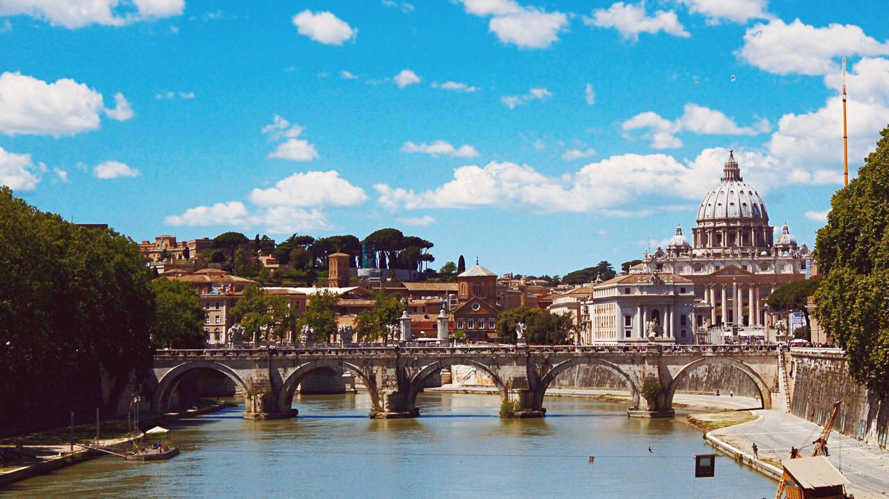 architecture, built structure, connection, bridge - man made structure, building exterior, sky, river, water, bridge, arch bridge, cloud - sky, arch, city, waterfront, cloud, engineering, transportation, canal, tree, travel destinations